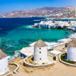 Aerial,View,Through,The,Famous,Windmills,Above,Mykonos,Town,,Cyclades,